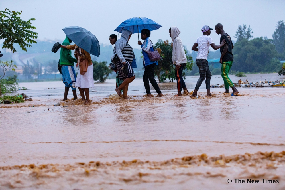 Residents wade through a flooded street in Kigali in 2020. Meteo Rwanda has alerted Rwandans that  many parts of Northern, Western and Southern Provinces with the exception of Amayaga region will have heavy rains. File
