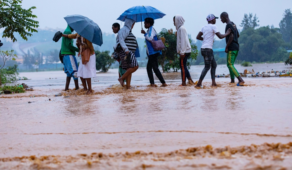 Residents wade through a flooded street in Kigali in 2020. Meteo Rwanda has alerted Rwandans that  many parts of Northern, Western and Southern Provinces with the exception of Amayaga region will have heavy rains. File
