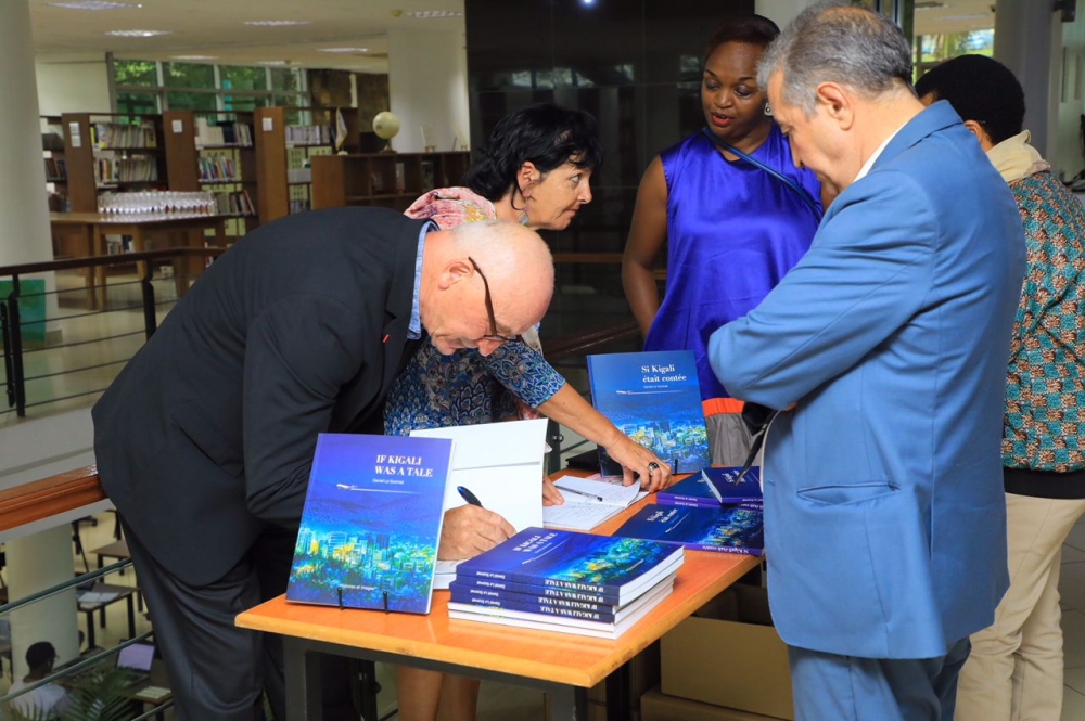 Daniel Le Scornet signs copies of his book ‘Si Kigali était contée’ or ‘If Kigali was a tale’, for clients during its launch in Kigali on November 3. Photos: Courtesy.