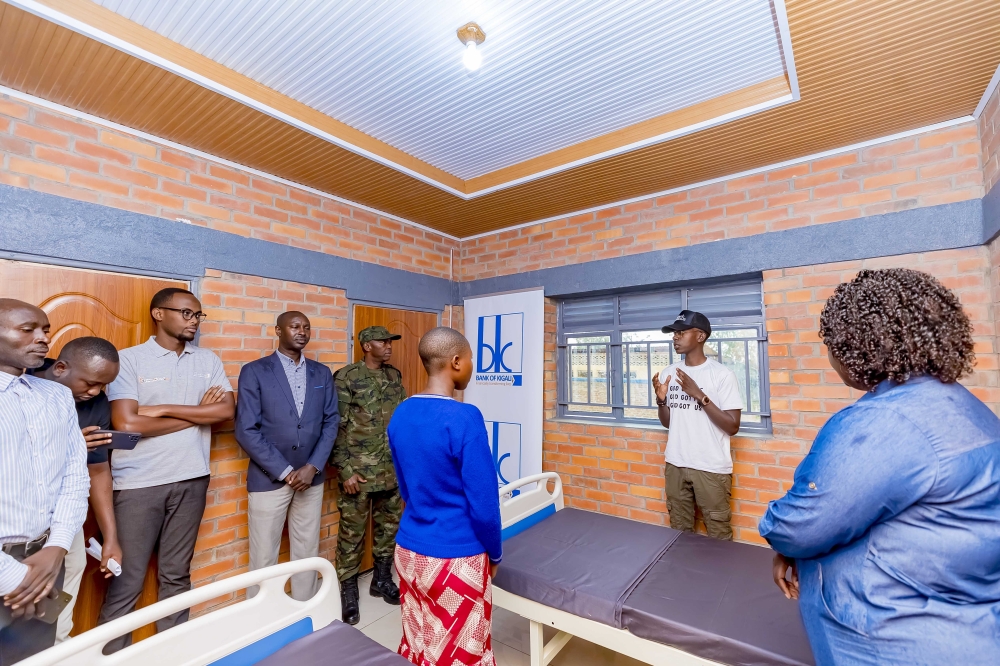 Christian Intwali, Founder of Our Past Initiative (2nd right), speaks inside the newly inaugurated girls’ room for menstrual hygiene management at
Ngeruka Primary School in Bugesera District on November 12. Photos: Courtesy.