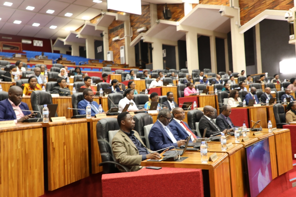 Members of Parliament follow Minister Bayisenge  while responding to different questions  about family conflicts and problems affecting society