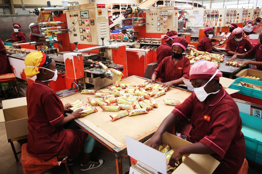 Workers pack biscuits at Adma International Ltd’s factory at Kigali Special Economic Zone in Gasabo District. Photo: Craish Bahizi.