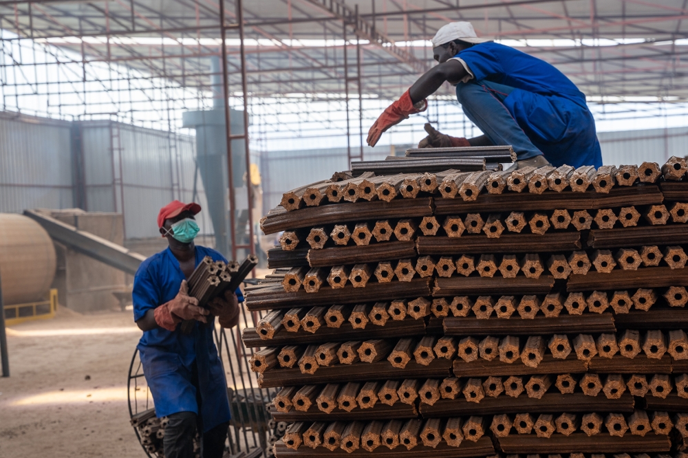 Workers sort briquettes at a factory which helps reduce the number of households depending on
firewood and charcoal for cooking. Photo: File.