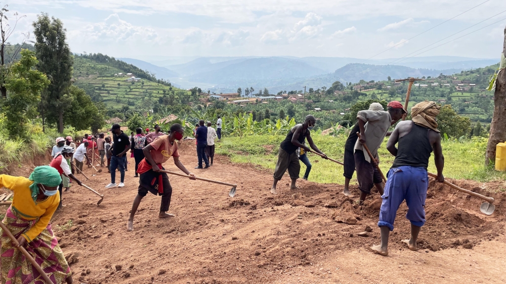 Residents work at a road maintenance project during Vision Umurenge Program in Ruhango District. Courtesy