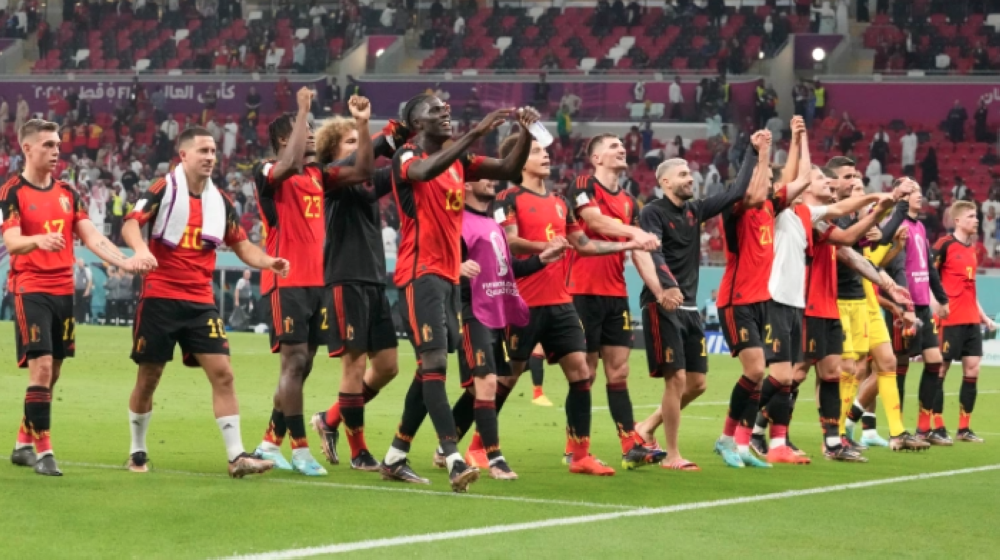 Belgian players celebrate after a hard fought win. (AP Photo/Darko Bandic3)