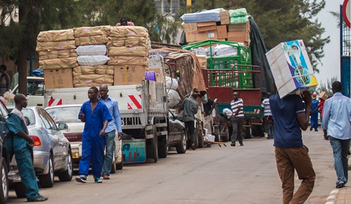Workers in Kigali’s Central Business District load cargo on upcountry bound trucks Supply deficiencies coupled with high costs of borrowing to produce
increases the prices of already scarce consumer goods even further which also diminishes consumer purchasing power. File Photo.