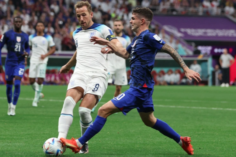 England&#039;s Harry Kane in action with Christian Pulisic, of the US, during the goalless draw between the two teams, November 25 [Paul Childs/Reuters]
