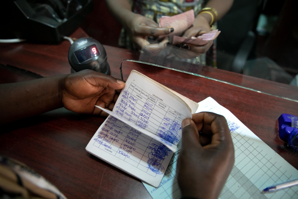 A SACCO client during her bank transactions. File
