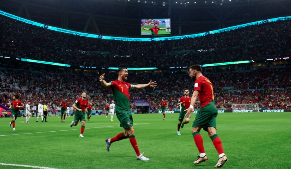 Ronaldo, left, and Fernades celebrate Portugal&#039;s first goal [Lee Smith/Reuters]