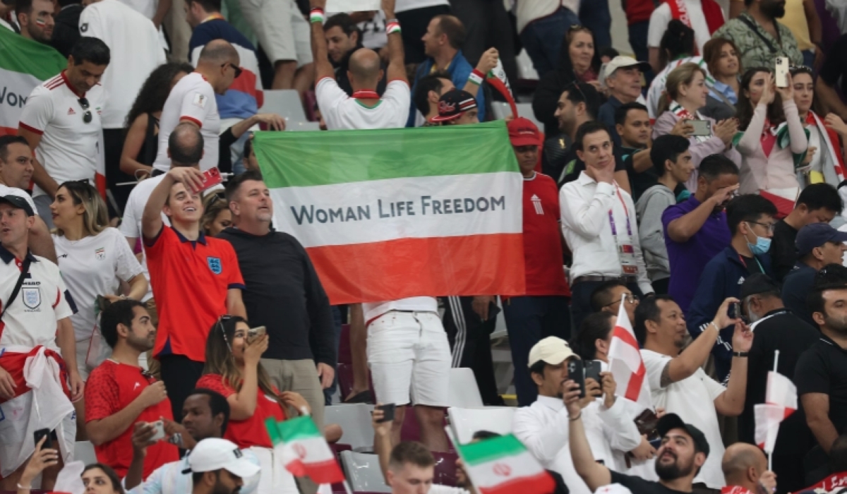 A man holds a &#039;Woman Life Freedom&#039; Iranian flag. [Showkat Shafi/Al Jazeera]