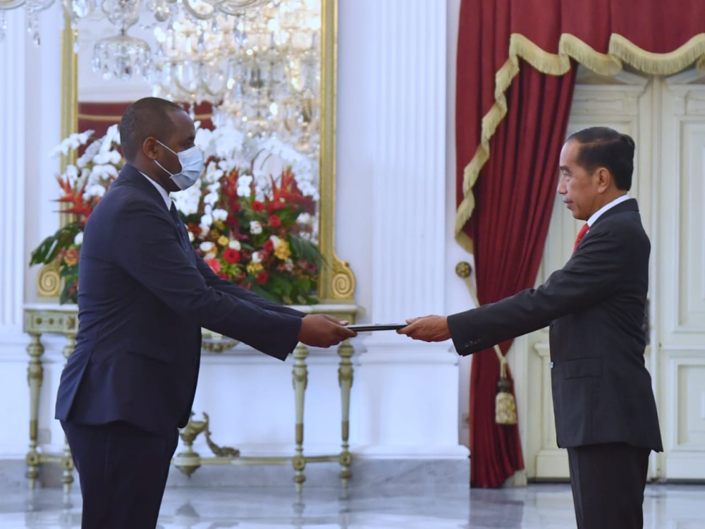 Amb. Uwihanganye (left) hands over his Letters of Credence to Indonesian President Joko Widodo at the Istana Merdeka Presidential Palace in Jarkata on Thursday, December 1.