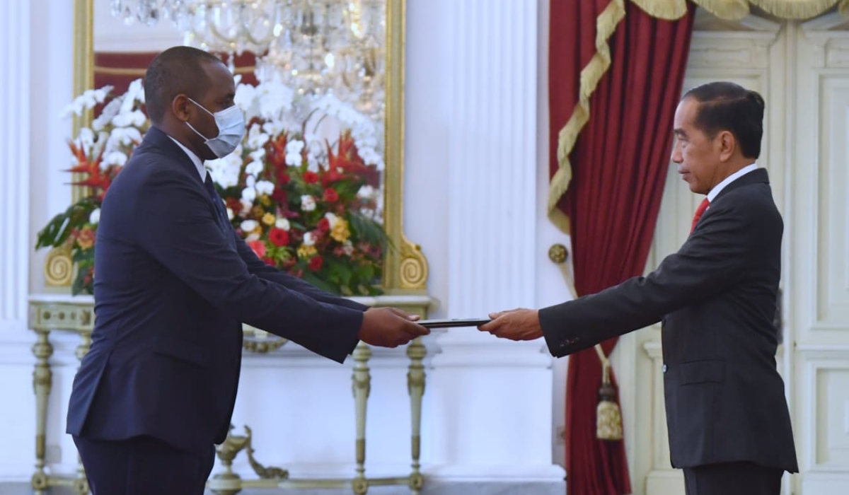 Amb. Uwihanganye (left) hands over his Letters of Credence to Indonesian President Joko Widodo at the Istana Merdeka Presidential Palace in Jarkata on Thursday, December 1.