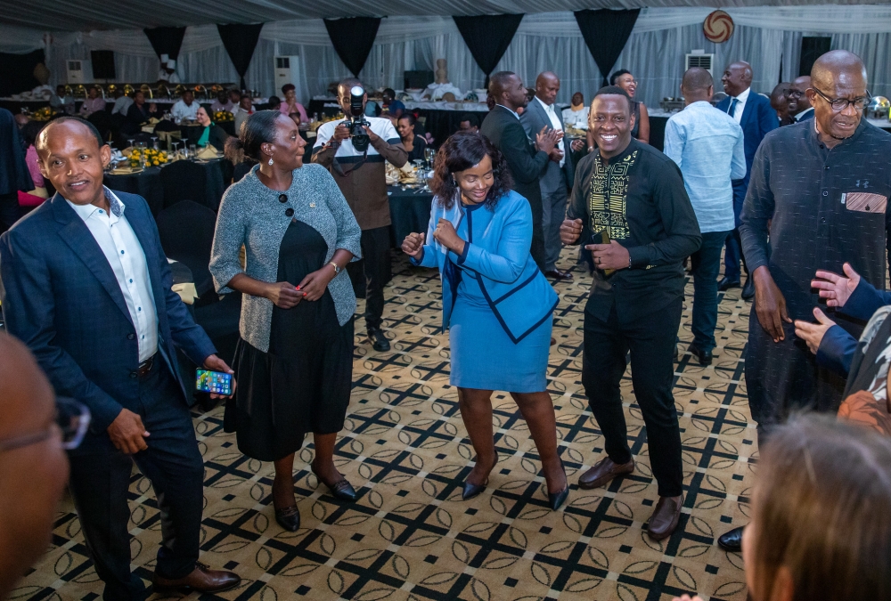 MTN Rwanda chief executive Mapula Bodibe (centre) and Board chair Faustin Mbundi (left) as well as other invitees, including former Cabinet minister and chief executive of Liquid Telecom Rwanda Sam Nkusi (right), show off their dancing skills at the gala dinner.