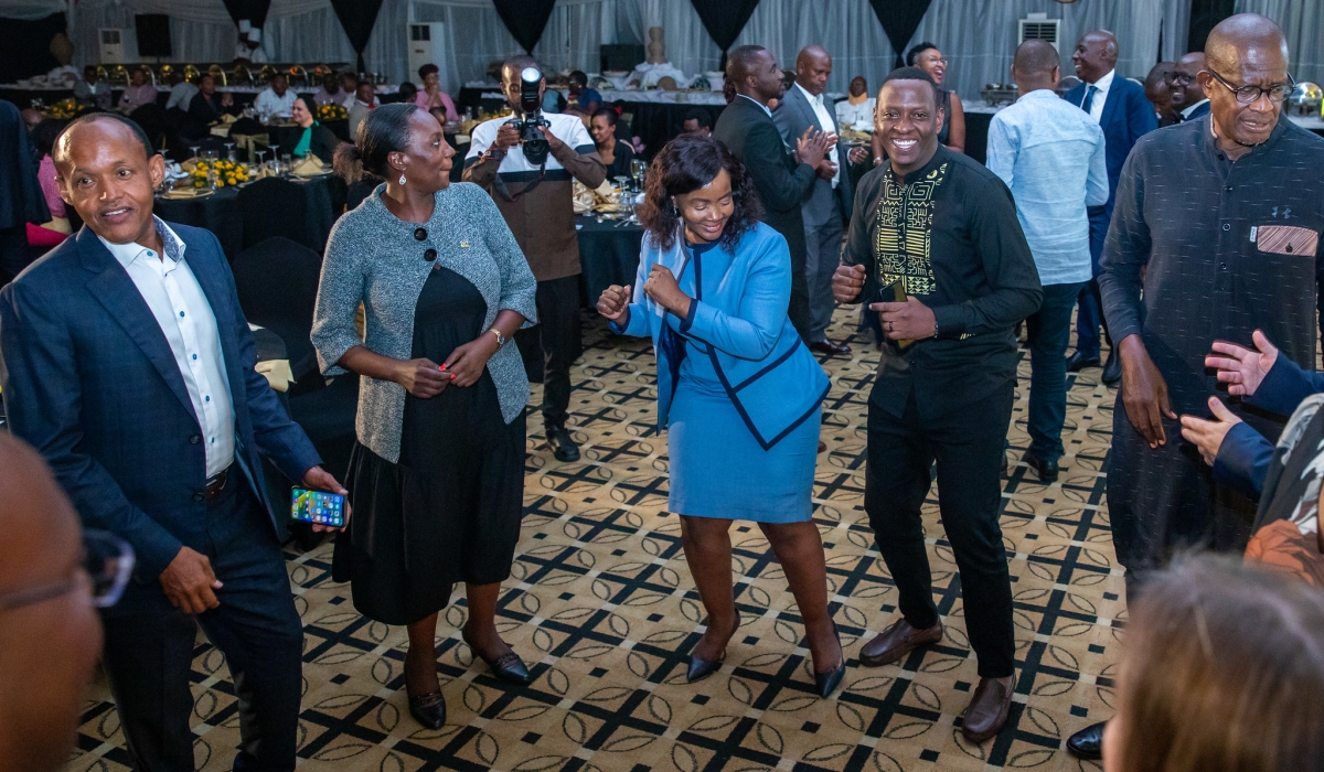 MTN Rwanda chief executive Mapula Bodibe (centre) and Board chair Faustin Mbundi (left) as well as other invitees, including former Cabinet minister and chief executive of Liquid Telecom Rwanda Sam Nkusi (right), show off their dancing skills at the gala dinner.