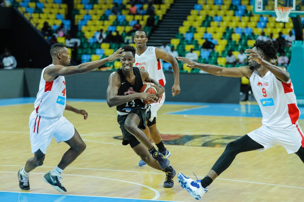 A Patriots player with the ball tries to go past REG Players during a past league game. Photo: Courtesy.