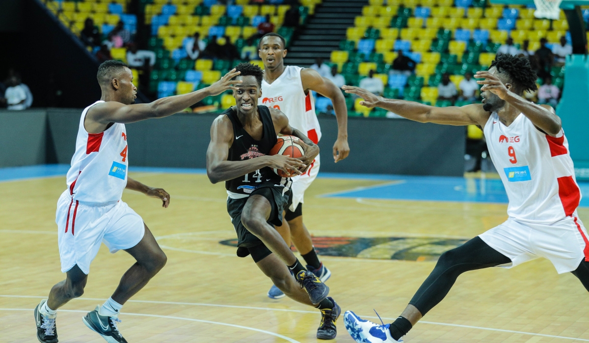 A Patriots player with the ball tries to go past REG Players during a past league game. Photo: Courtesy.