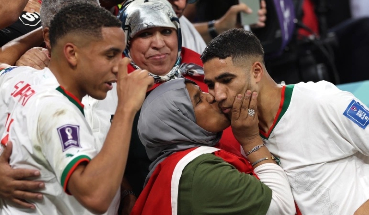 Moroccan defender Achraf Hakimi (R) is greeted by his mother at the end of the Qatar 2022 World Cup Group F match against Belgium [Fadel Senna/AFP]