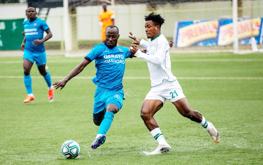 Police FC attacking midfielder Eric Nsabimana battles for the ball with SC Kiyovu player during the game at Kigali Stadium. Olivier Mugwiza