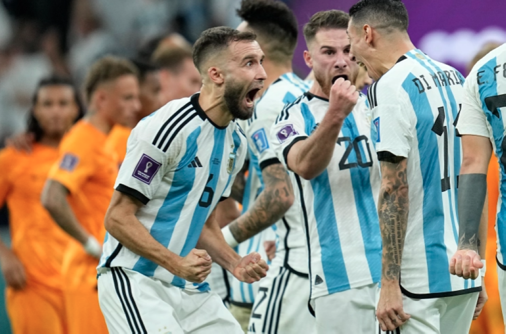 Argentina players celebrate during the penalty shootout in the World Cup quarterfinal soccer match between the Netherlands and Argentina [Ebrahim Noroozi/AP Photo]