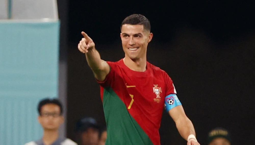 Portugal’s Cristiano Ronaldo celebrates after scoring against Ghana at the 2022 FIFA World Cup on November 24, making him the only player in history to have scored in five World Cups [Reuters/Hannah Mckay]