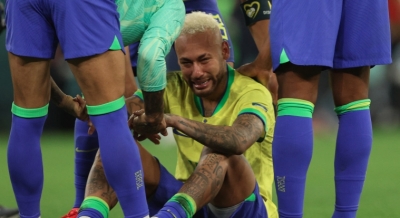 Brazil's Neymar is consoled by teammates after their quarter-final loss to Croatia at Education City Stadium Doha, on December 9, 2022 [Adrian Dennis/AFP]