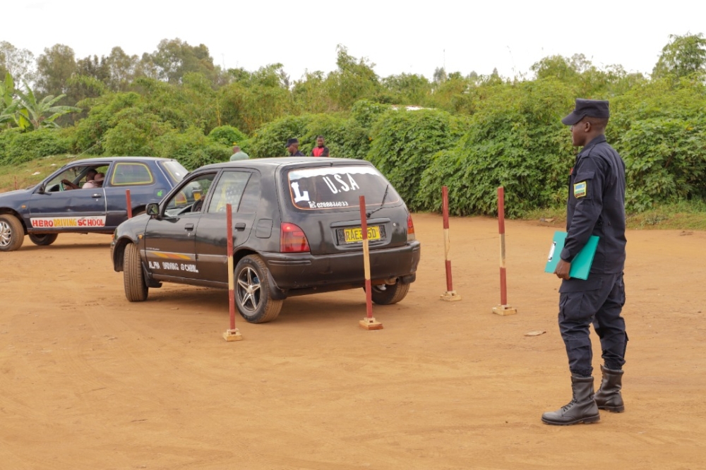 Rwanda National Police officer invigilates at the  definitive driving tests that  started on Monday, December 12, in the City of Kigali. Courtesy