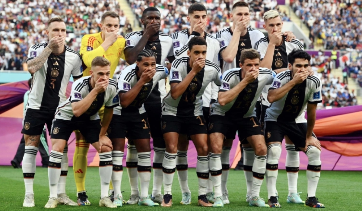 Germany players covered their mouths as they posed for their team group photo before their opening World Cup match against Japan [Annegret Hilse/Reuters]