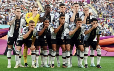 Germany players covered their mouths as they posed for their team group photo before their opening World Cup match against Japan [Annegret Hilse/Reuters]