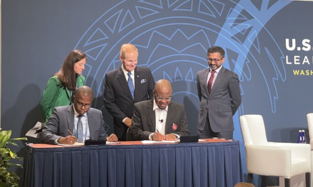 Chief Executive Officer of the Rwanda Space Agency, Col Ngabo Francis (Left) and the Nigerian representative sign the agreement in Washington on December 13. Courtesy