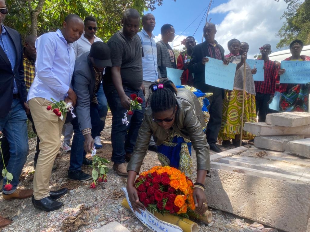 Friends and relatives of the victims lay bouquets in Nyungwe earlier Friday. Photos by Moise Bahati