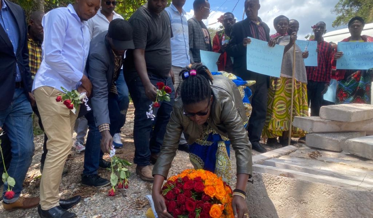 Friends and relatives of the victims lay bouquets in Nyungwe earlier Friday. Photos by Moise Bahati