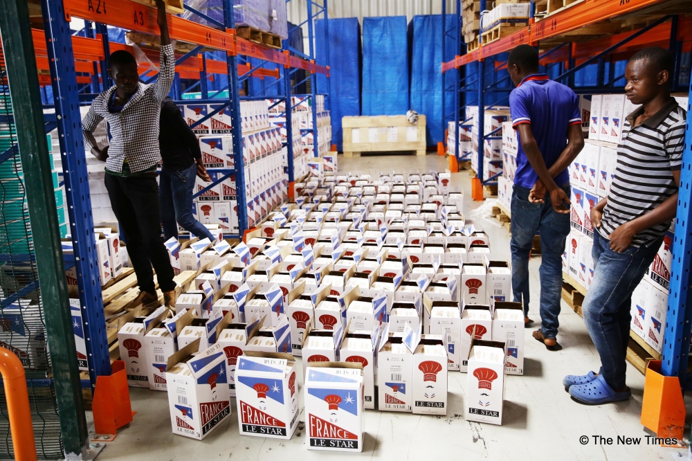 Workers offload a store of some imported products at Dubai Port in Kigali. Tax on imported food and cosmetics have drastically increased. Craish Bahizi