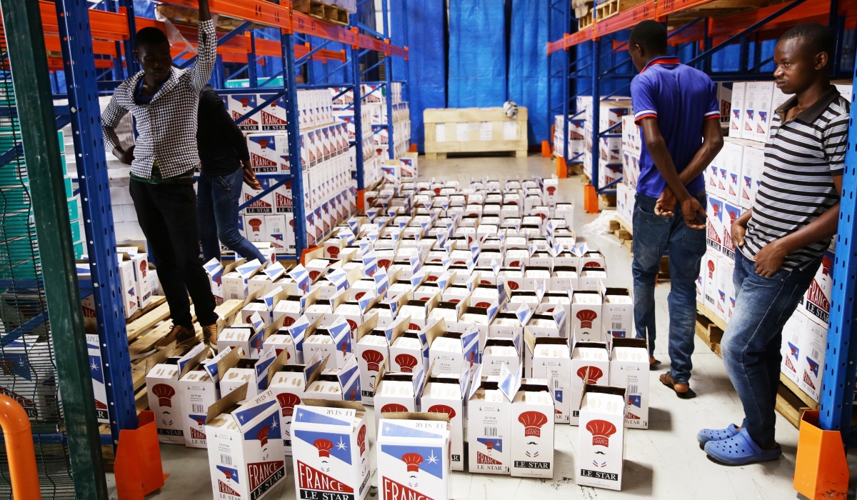 Workers offload a store of some imported products at Dubai Port in Kigali. Tax on imported food and cosmetics have drastically increased. Craish Bahizi