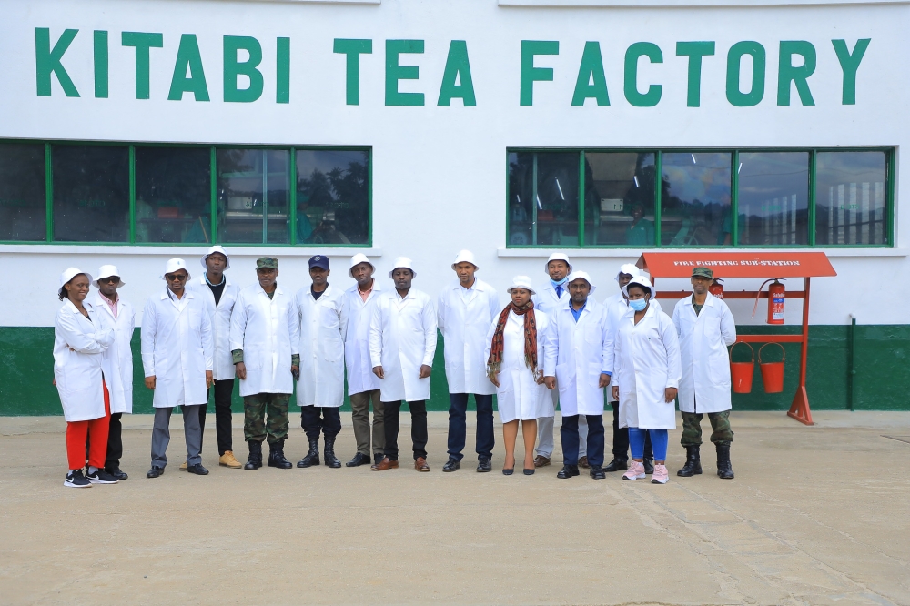 Visitors and officials pose for a group photo after a guided tour of of  Kitabi Tea Factory as Rwanda Mountain Tea Ltd  celebrated with farmers and tea pluckers their annual Tea Farmers’ Day across all their 8-tea gardens and factories on Thursday December 15. All Photos by Craish BAHIZI
