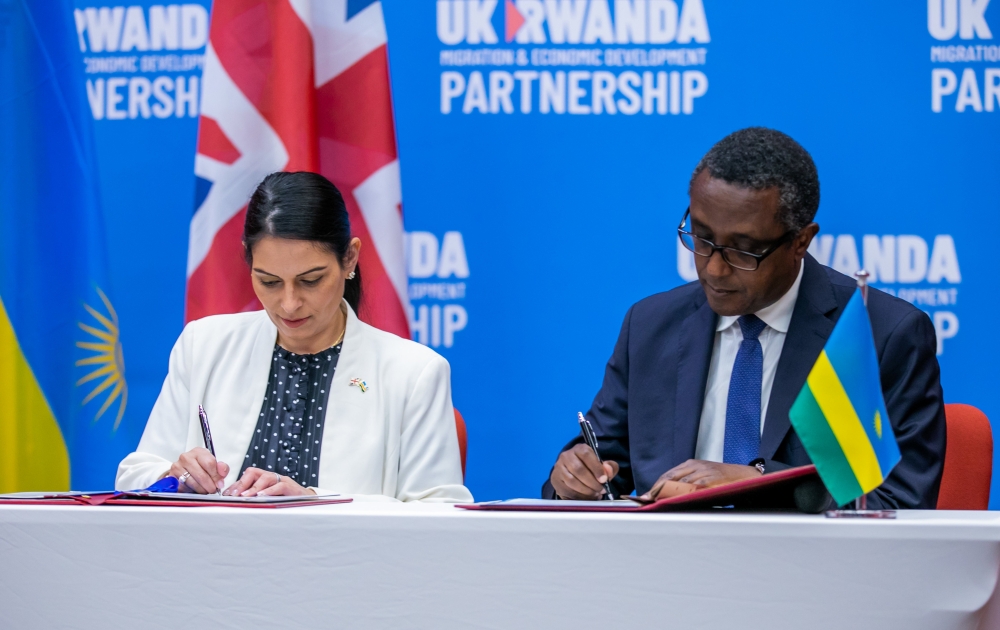 The Minister of Foreign Affairs and International Cooperation Dr. Vincent Biruta and Priti Patel, the former Home Secretary of the United Kingdom sign the agreement  in Kigali on April 14,2022. File