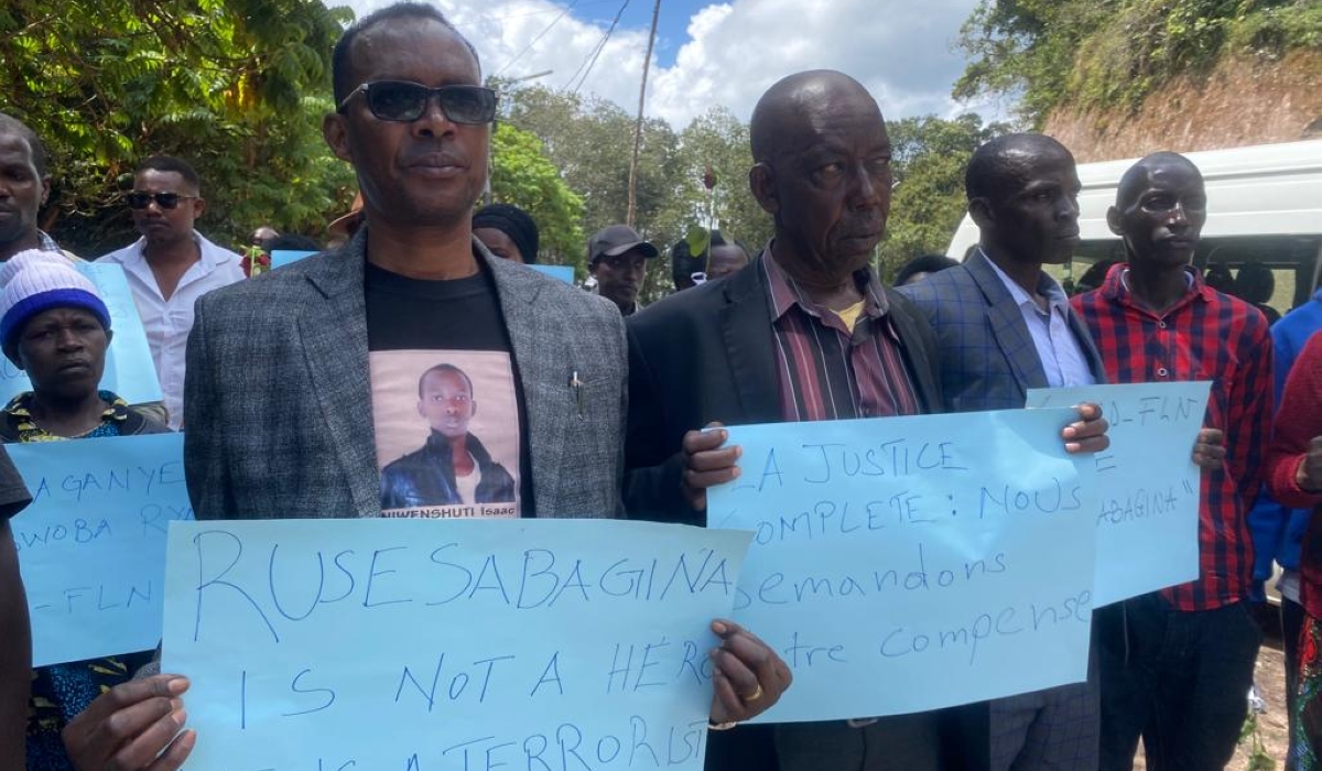 Phenias Karegesa, the father of Isaac Niwenshuti, a 17-year-old boy who was burnt in one of the buses. Seen here with other mourners  during the commemoration event of the victims of the attacks ,on Friday, December 16.