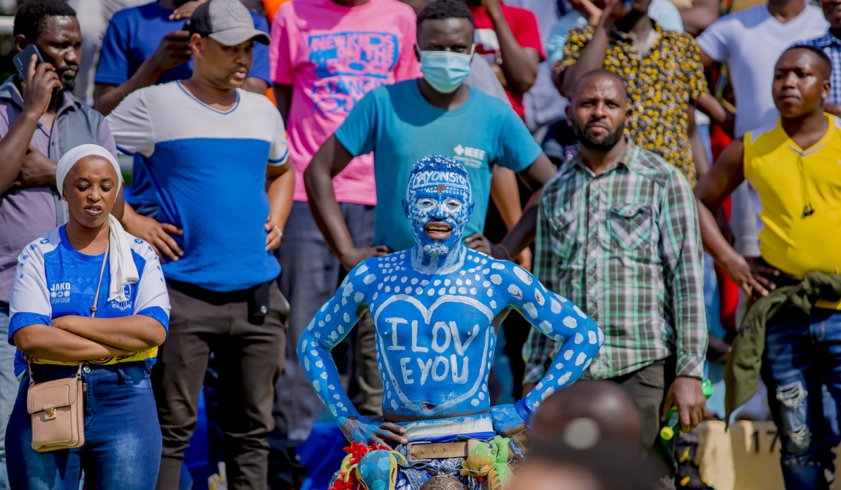 Rayon Sports fans look so discouraged while looking how APR&#039;s goal scorer Yannick Bizimana is lifted up by his teammate during the celebration of the victory as APR FC beat Rayons Sports 1-0 at Kigali Stadium on Saturday December 17. Photo by Christophe Renzaho