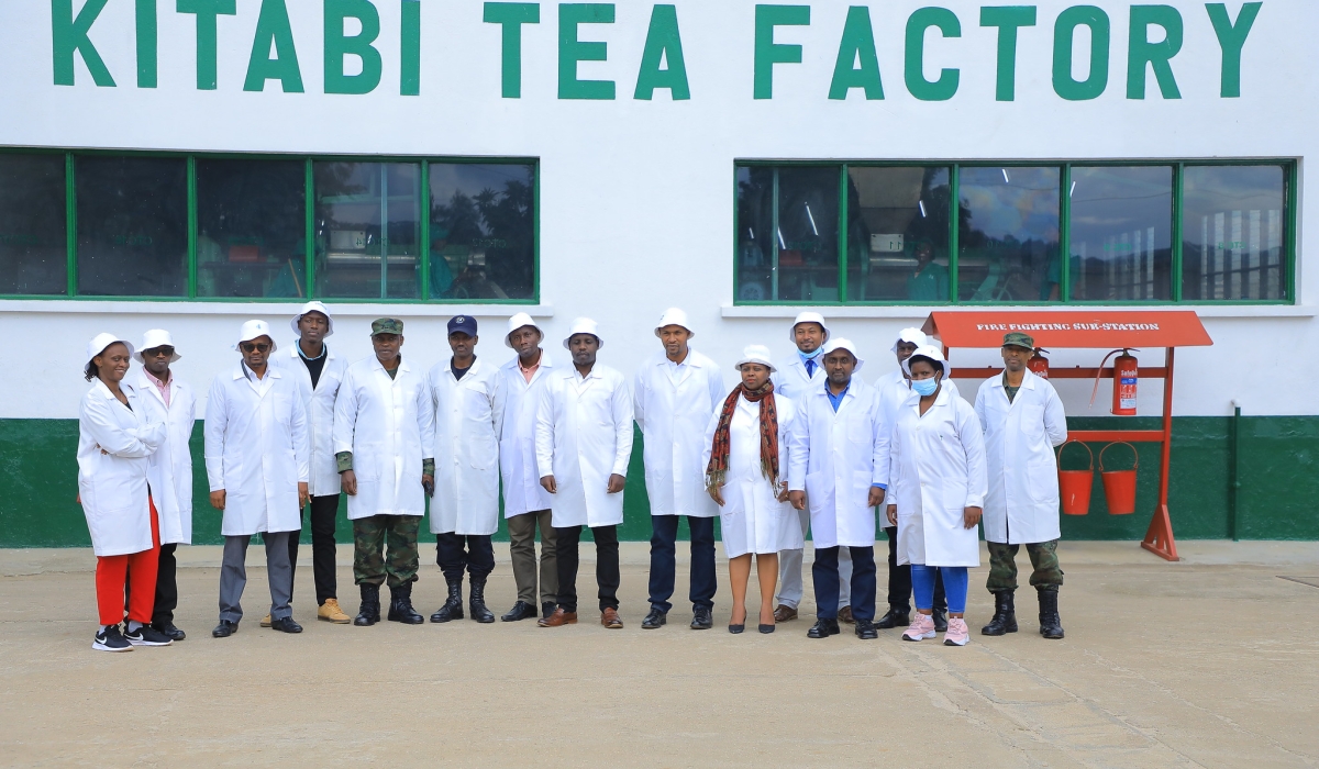 Visitors and officials pose for a group photo after a guided tour of of  Kitabi Tea Factory as Rwanda Mountain Tea Ltd  celebrated with farmers and tea pluckers their annual Tea Farmers’ Day across all their 8-tea gardens and factories on Thursday December 15. All Photos by Craish BAHIZI