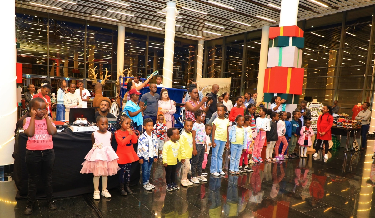 Parents with their children during a ceremony of festive season for kids at Kigali Convention Center last week. Craish BAHIZI