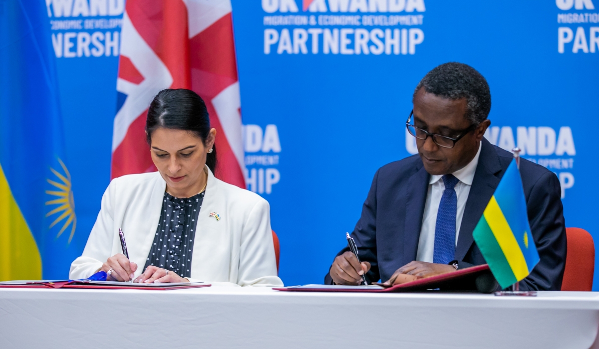 The Minister of Foreign Affairs and International Cooperation Dr. Vincent Biruta and Priti Patel, the former Home Secretary of the United Kingdom sign the agreement  in Kigali on April 14,2022. File