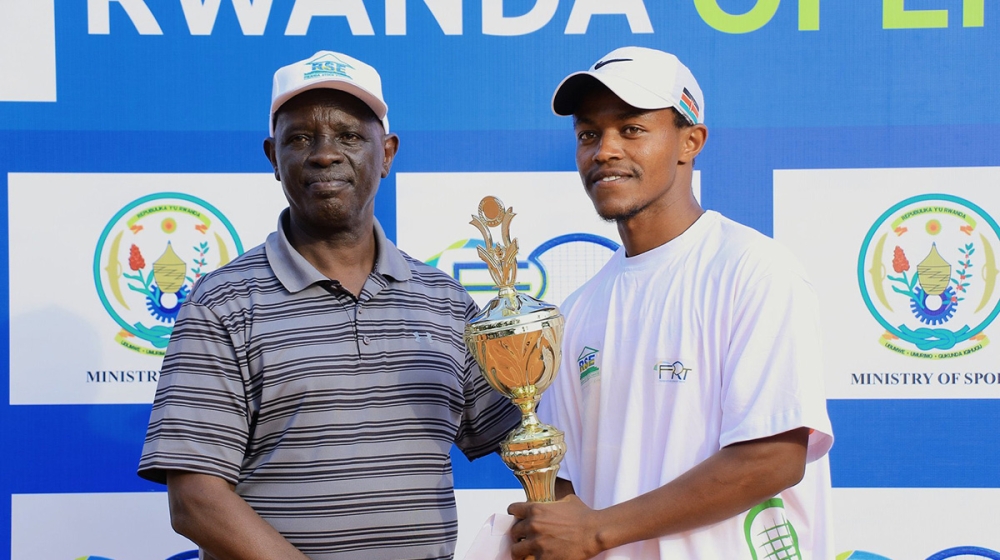 Rwanda Tennis Federation president Theoneste Karenzi awards one of winners of Rwanda Open 2022. Courtesy