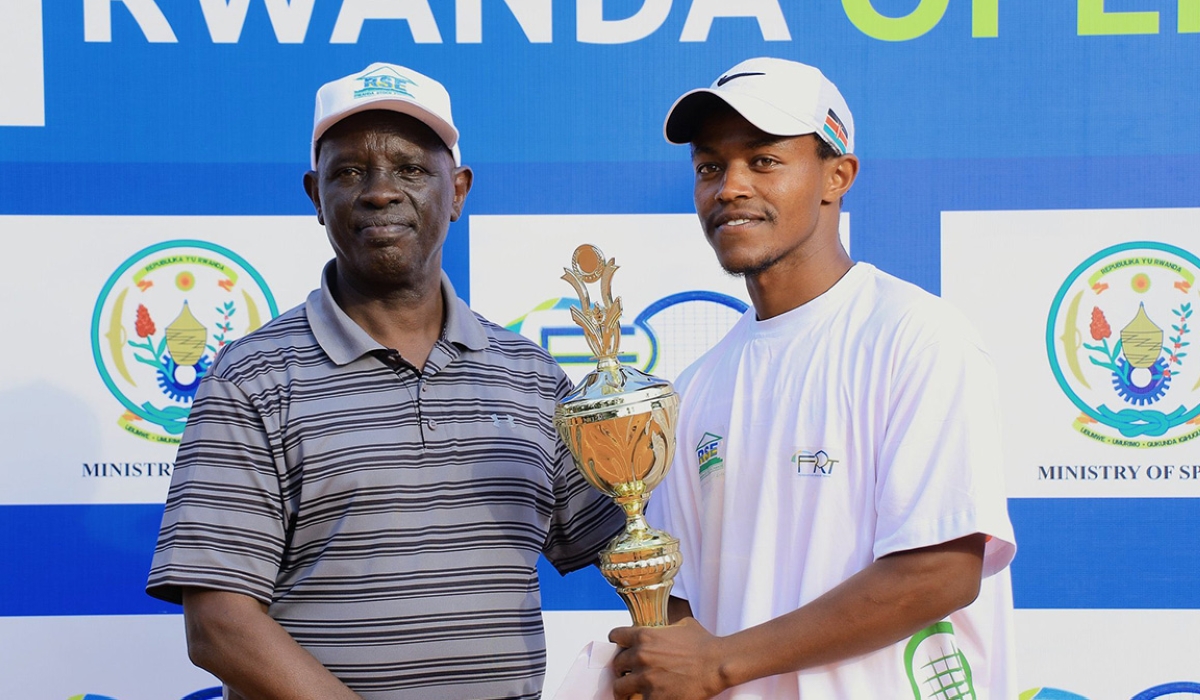 Rwanda Tennis Federation president Theoneste Karenzi awards one of winners of Rwanda Open 2022. Courtesy