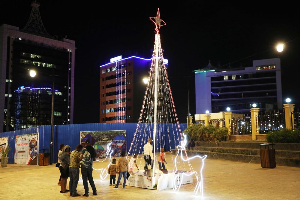 Residents in Kigali take pictures of festive seasons decoration at Imbuga City walk on December 22. Craish Bahizi
