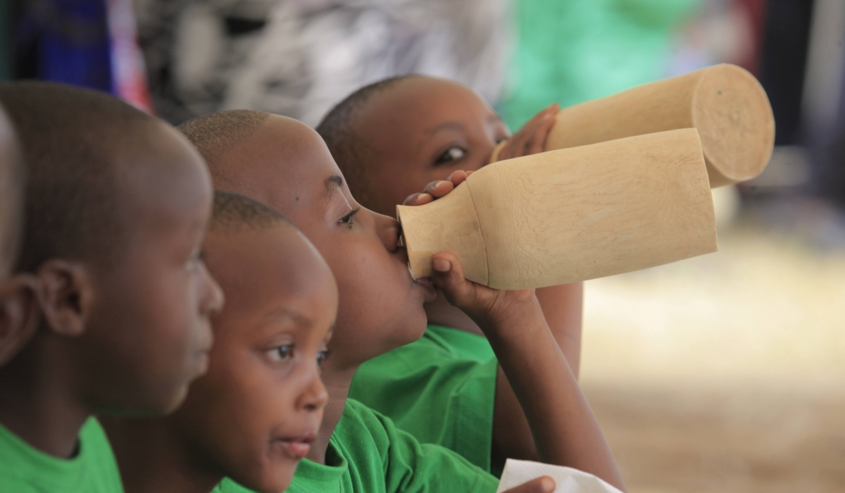 Children drink milk during Umuganura .Using Kinyarwanda among parents and children may not be so common and, indeed, it should be encouraged.