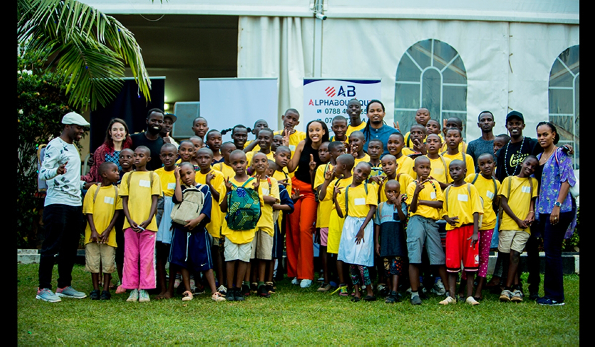 Sheer love Rwanda children share a picture moment with the YB Foundation team, and guests at Spiderman Game Centre limited , shortly after receiving their scholastic items