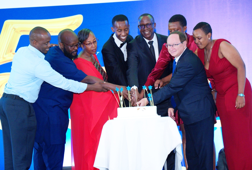 Ambassador of Israel to Rwanda Ron Adam and Minister Jean Damascene Bizimana join Peace and Love Proclaimers (PLP)  members to cut the cake  during  the PLP ceremony to  mark  its 15th anniversary at the Radisson Blu Hotel on December 28. Courtesy