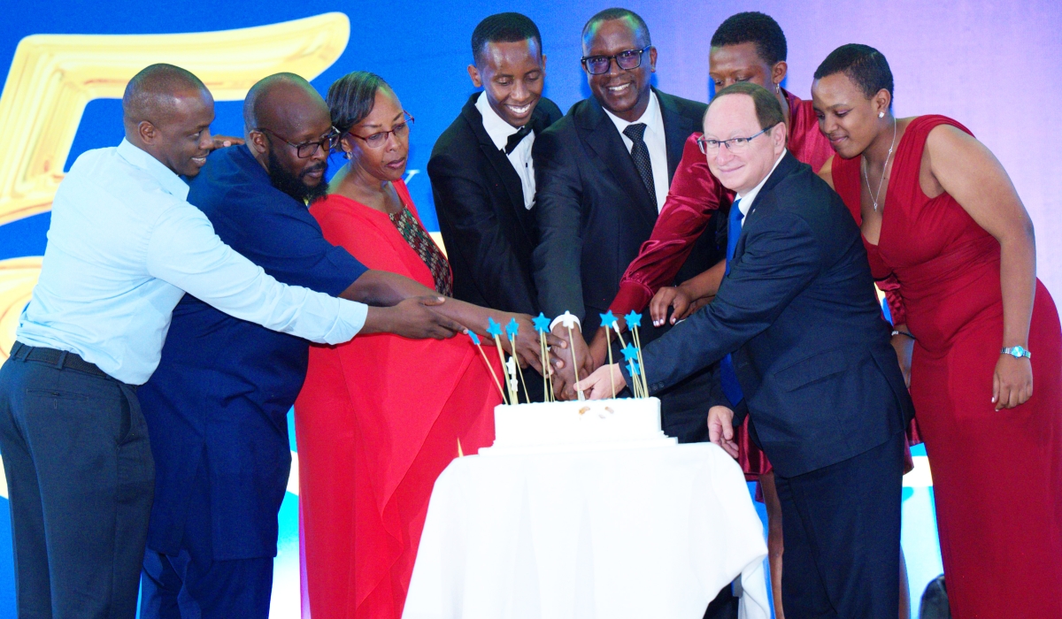  Ambassador of Israel to Rwanda Ron Adam and Minister Jean Damascene Bizimana join Peace and Love Proclaimers (PLP)  members to cut the cake  during  the PLP ceremony to  mark  its 15th anniversary at the Radisson Blu Hotel on December 28. Courtesy