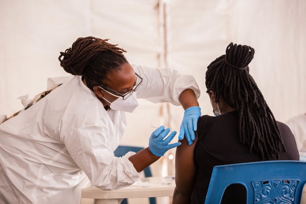 A health worker conducts the Covid 19 vaccination activity in Kigali. Rwanda raised its Covid-19 vaccination targets the revision means that Rwanda now aims to vaccinate 69.4 % of her population by the
end of 2022. Photo by Craish Bahizi