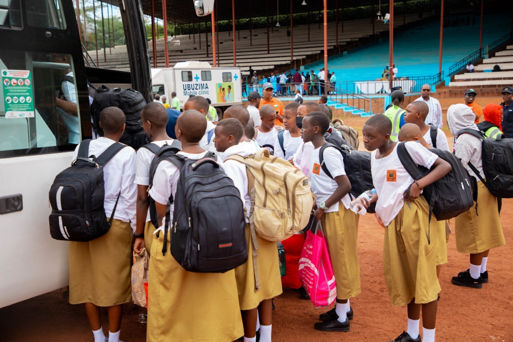 Students at ULK stadium  board buses as they start returning to their respective schools on Thursday, January 5..Transporters have been warned against hiking transport fare during the return to school period. All Photos by Dan Kwizera