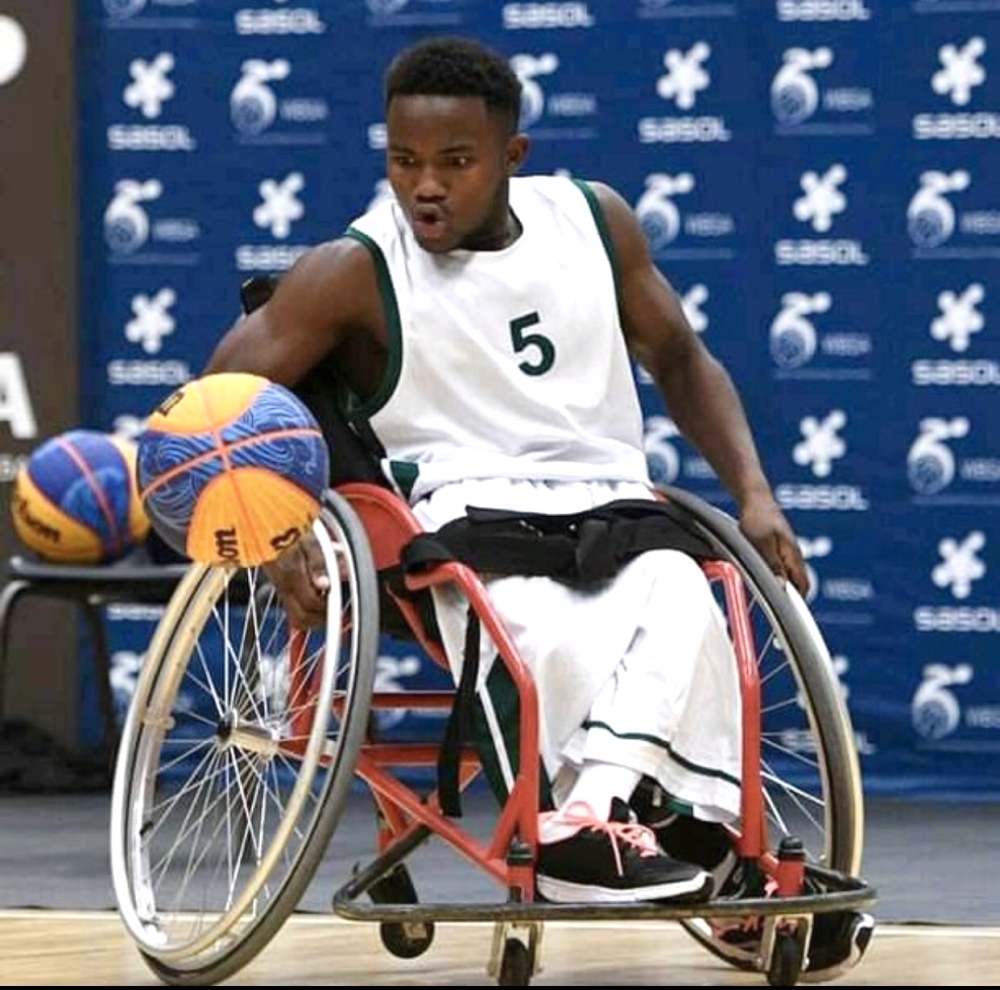 Munyaneza applies speed on the wheelchair to grab the ball.